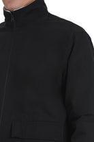 Black zip-up jacket with a high collar and front pocket.