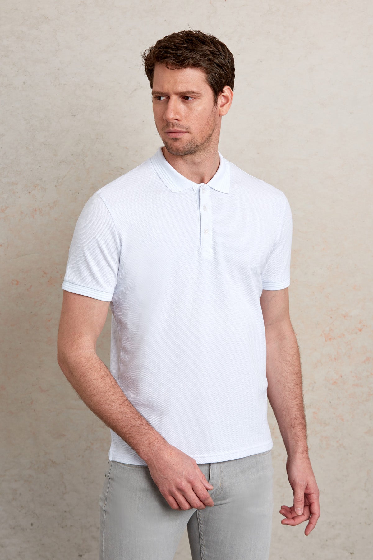 White short-sleeved polo shirt with a classic collar and button placket.