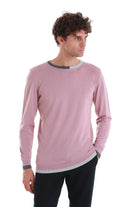 A soft pink long-sleeved sweater with a ribbed crew neck and cuffs accented in gray.
