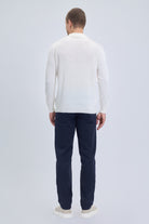 A man wearing a white regular fit johnny polo sweater in wool blend with dark navy trousers
