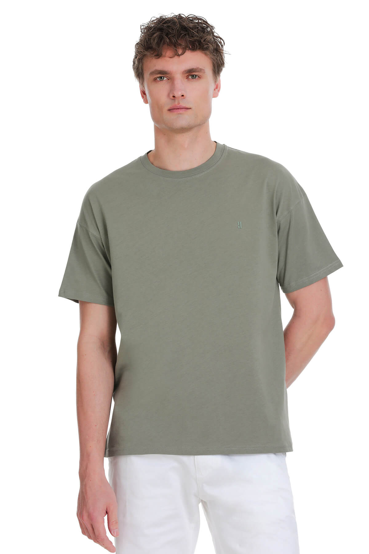 Sage green oversize crew neck t-shirt with olive green fabric and small embroidered logo on the left chest