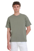 Sage green oversize crew neck t-shirt with olive green fabric and small embroidered logo on the left chest