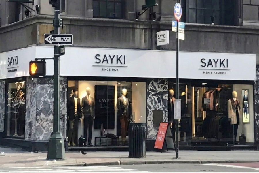 SAYKI store front with mannequins and clothing on a city street