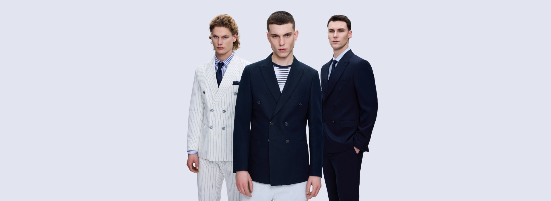 Three men wearing SAYKI double-breasted suits in white pinstripe, navy, and dark navy — SAYKI menswear collection