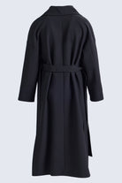 Black wool coat with belted waist and notched collar from sayki woman dynamic fit cachet oversized collection