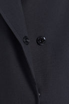 Black satin fabric with two glossy black buttons on sayki woman dynamic fit cachet black oversized coat