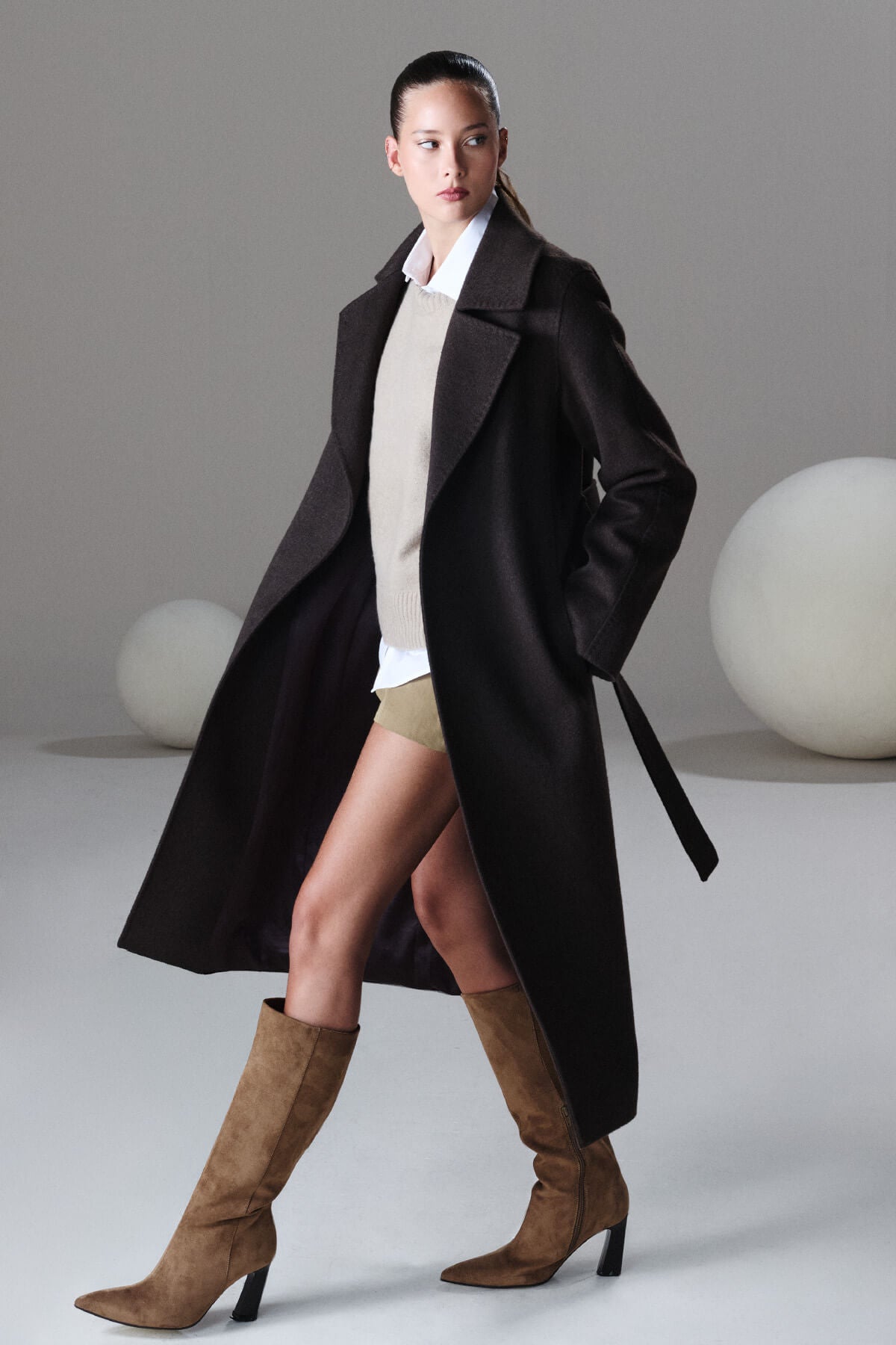 Black wool trench coat with belted waist and wide lapels from sayki woman dynamic fit cachet collection