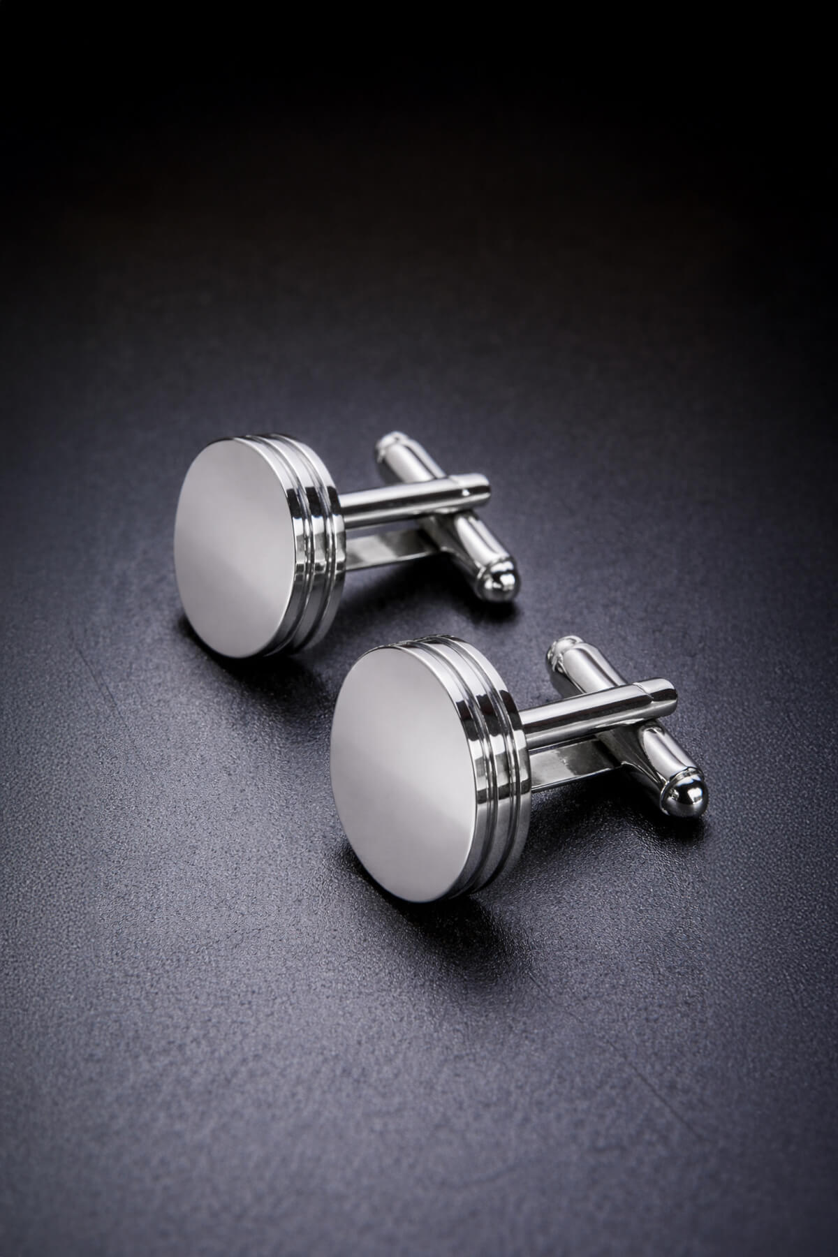 Silver toned natural stone round cufflinks shaped like engine pistons with polished metallic finish and three ridges