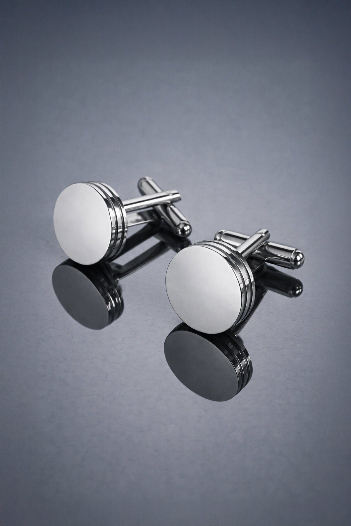 Silver toned natural stone round cufflinks with polished piston shape and two horizontal grooves on each face