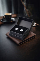Silver toned natural stone square cufflinks displayed in a black gift box for formal wear