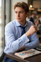 Light blue dress shirt with subtle texture and cufflinks featuring silver toned natural stone square design with navy tie