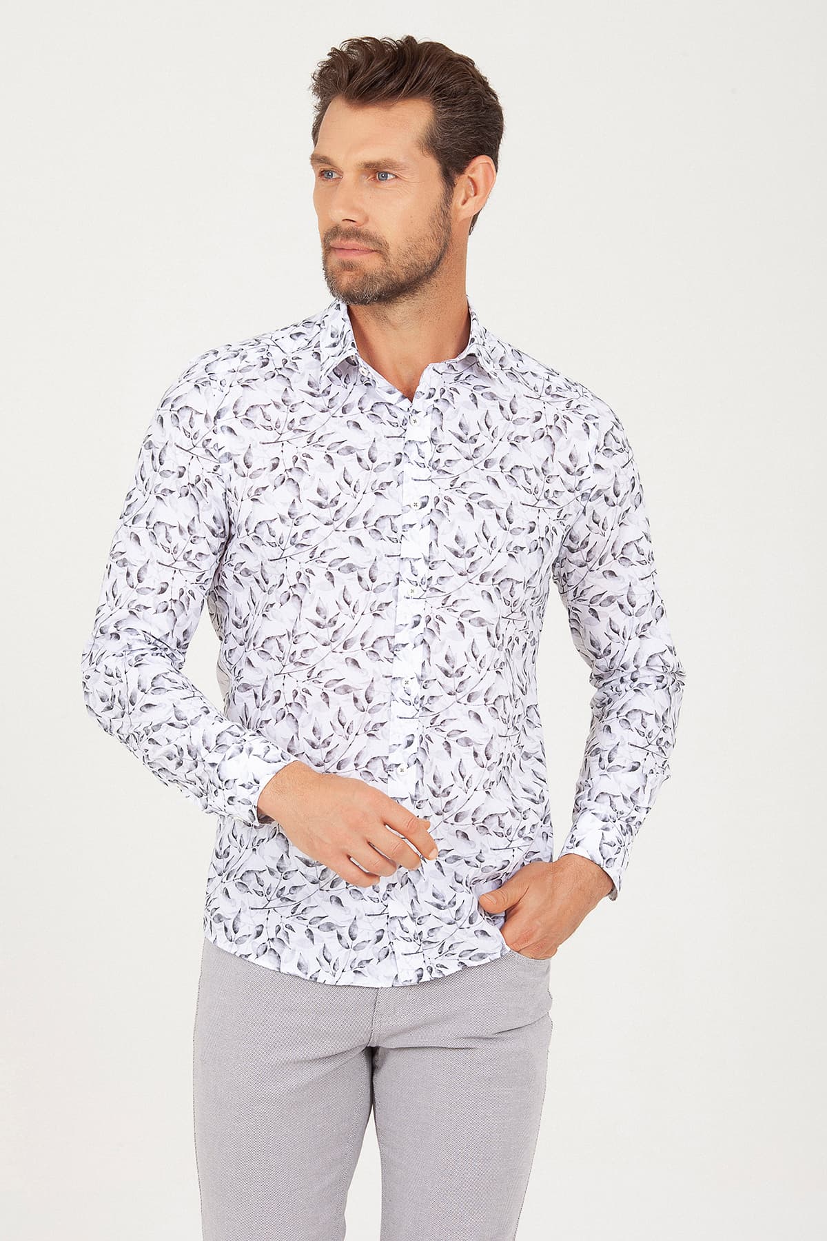White long-sleeved button-up shirt with a subtle black leaf pattern.