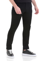 Black slim-fit trousers made of smooth, stretchy fabric with a sleek, modern design.