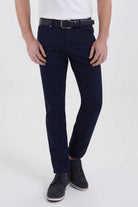 Navy blue slim-fit chinos with a subtle texture and matching belt