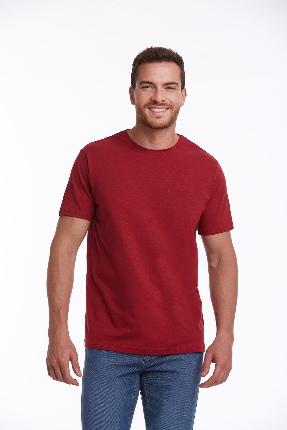 A man wearing a solid red, short-sleeved crew neck t-shirt.