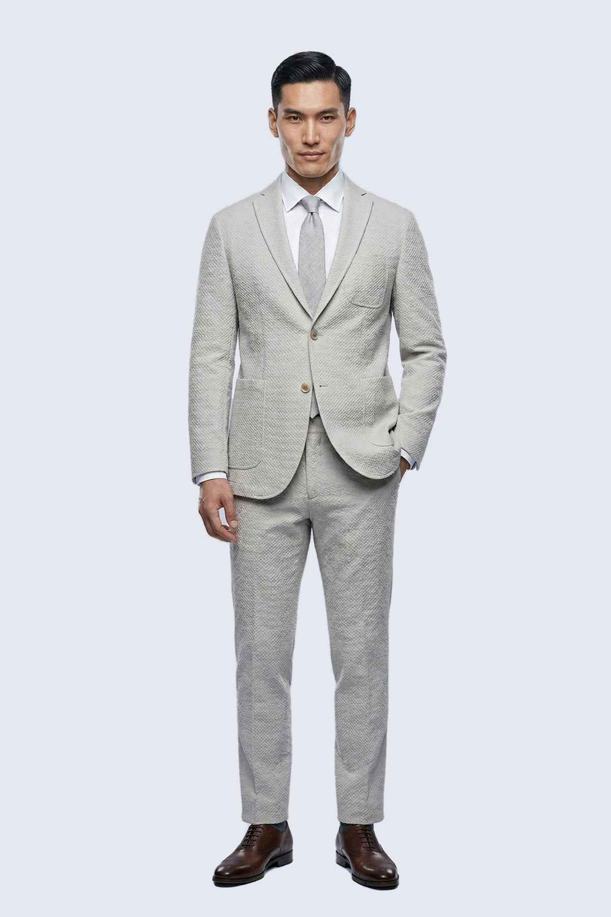 Slim fit beige notch lapel classic blazer in light gray textured fabric with subtle pattern and matching trousers