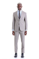 A tailored beige suit with a classic two-button design and matching trousers.