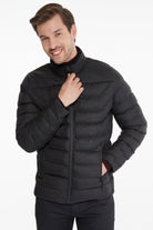 Black quilted puffer jacket with a high collar and front zipper.