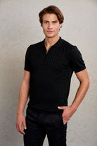 Black ribbed knit polo shirt with a subtle zipper detail at the collar.