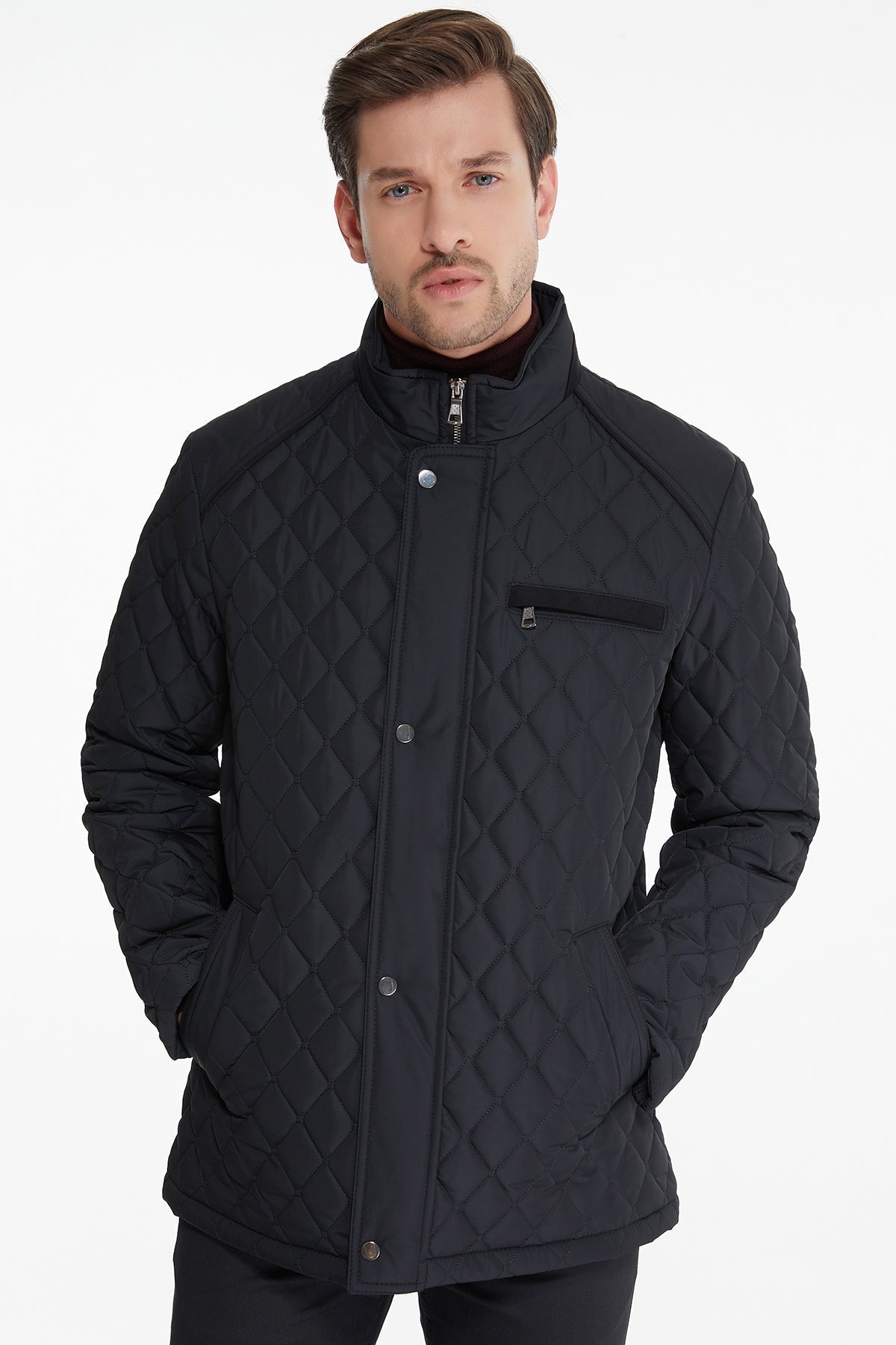 Black quilted jacket with diamond stitching and silver-toned buttons.