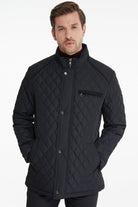 Black quilted jacket with diamond stitching and silver-toned buttons.