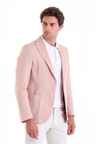 A light pink, textured blazer with a single button closure and flap pockets.