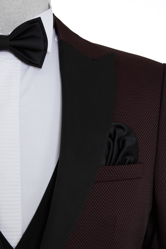 A burgundy textured tuxedo jacket with black satin lapels and a matching black pocket square.