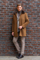 Brown wool overcoat with a dark fur-lined collar.