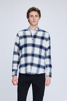 A navy and white plaid flannel shirt with a soft, textured fabric.