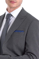 Dark gray textured wool suit jacket with a matching patterned tie and navy blue polka-dot pocket square.