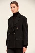 Black double-breasted blazer with gold-toned buttons and structured shoulders.