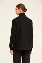 Black tailored blazer with three-button cuffs and a high collar