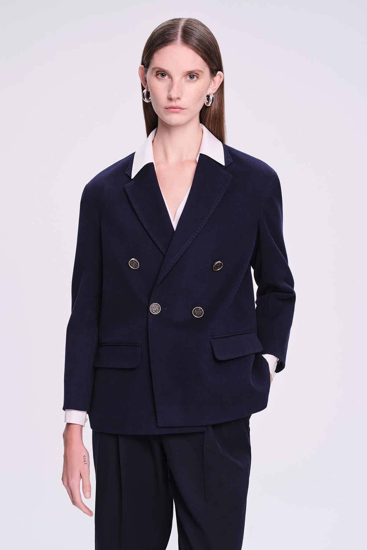 Navy blue double-breasted blazer with white collar and gold-toned buttons