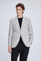Light gray tailored blazer with a sleek, modern cut and subtle texture.
