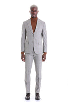 A tailored light gray suit with a subtle check pattern, featuring a single-breasted jacket and matching trousers.