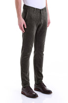 Dark olive green corduroy trousers with a slim fit and classic five-pocket design.