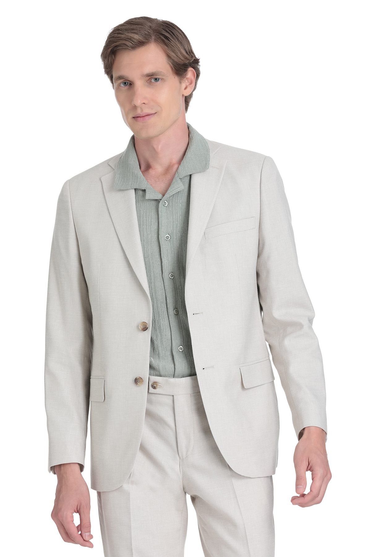 A light beige tailored blazer with a subtle texture and matching trousers, worn over a pale green button-up shirt.