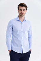 Light blue, subtly striped men’s dress shirt with a classic collar and button-down front.