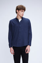 Navy blue long-sleeved button-up shirt with a classic collar and subtle texture