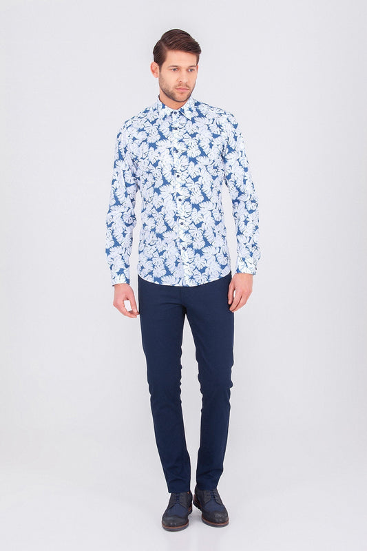 A man wearing a long-sleeved button-up shirt with a white base and blue floral pattern.