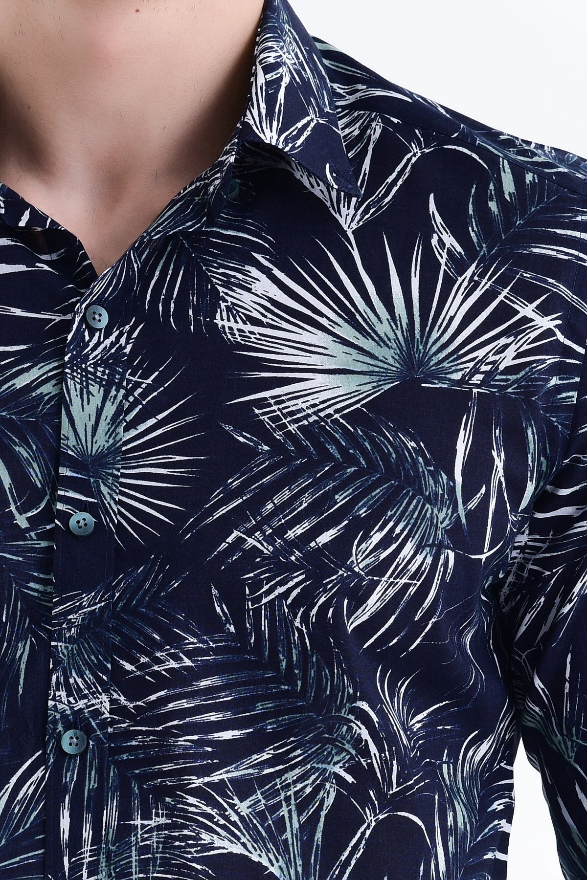 Dark blue button-down shirt with a bold white tropical palm leaf pattern.