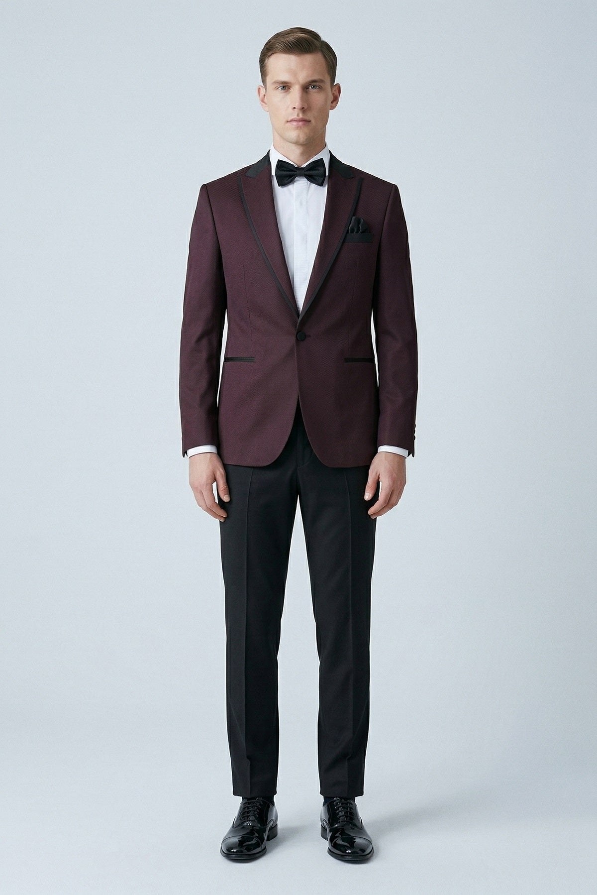 Slim fit micro grid burgundy classic tuxedo with peak lapel black satin trim and matching bow tie for formal occasions