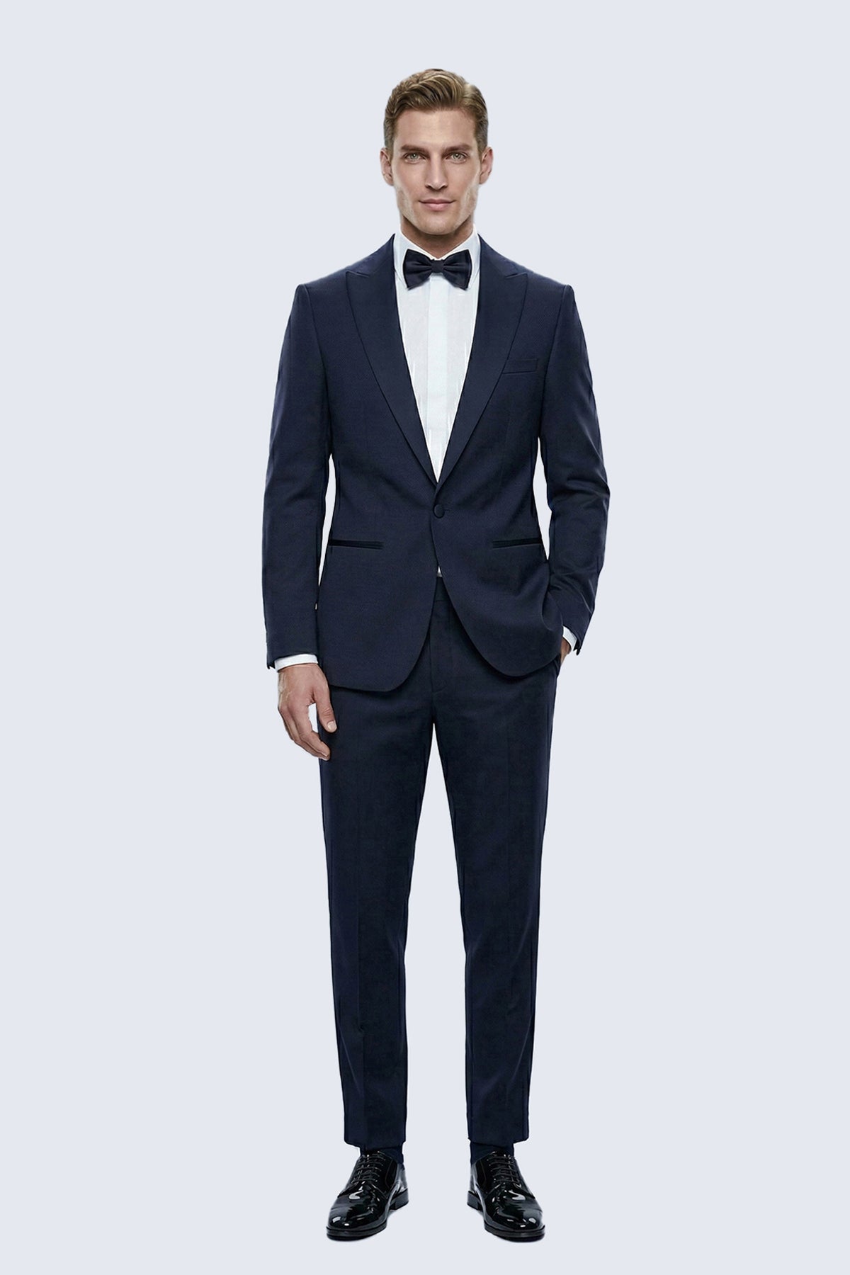 Slim fit navy peak lapel classic tuxedo in tailored fabric with matching trousers for formal occasions