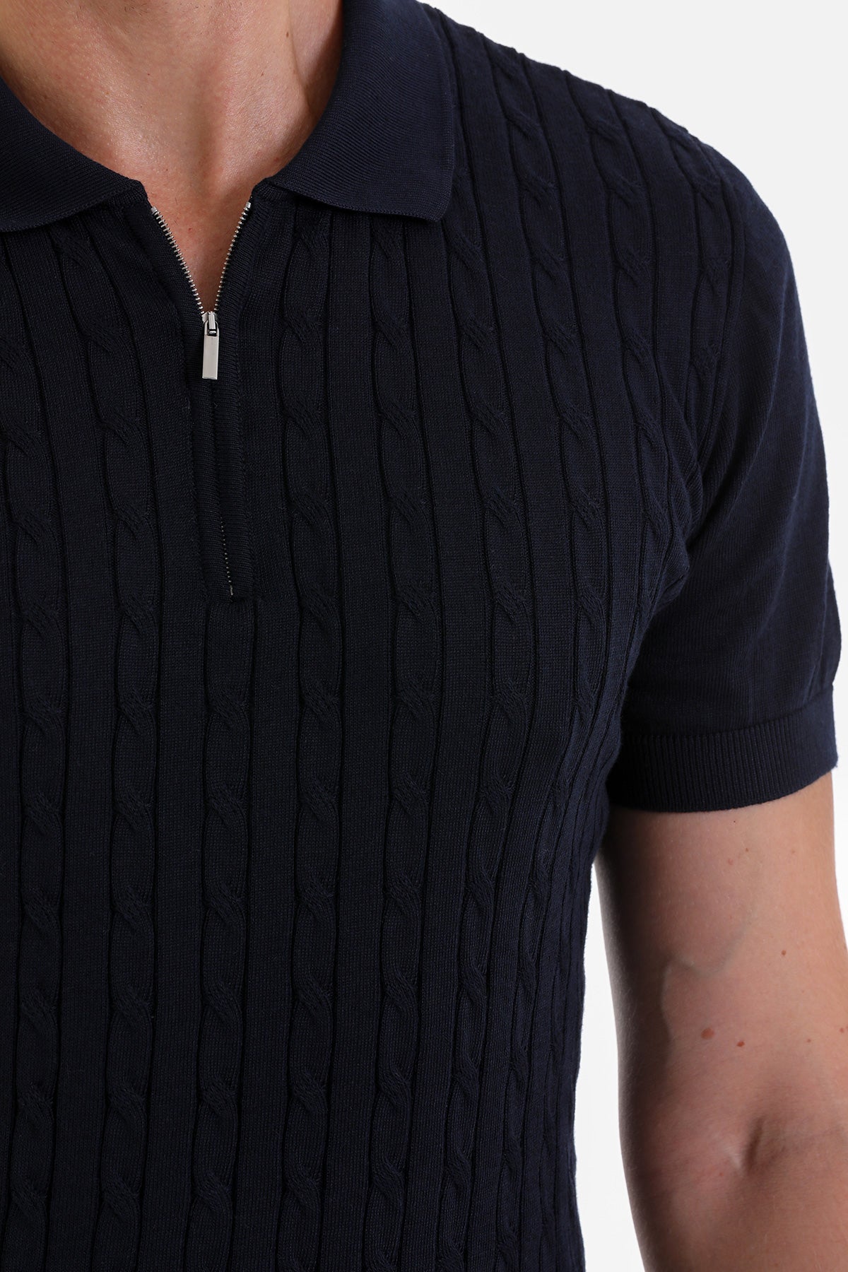 Navy blue cable-knit polo shirt with a silver zipper at the collar