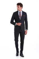 A sharply tailored black suit with a subtle texture, featuring a matching vest and trousers.