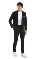 Black tailored blazer with a subtle textured weave and a white pocket square.