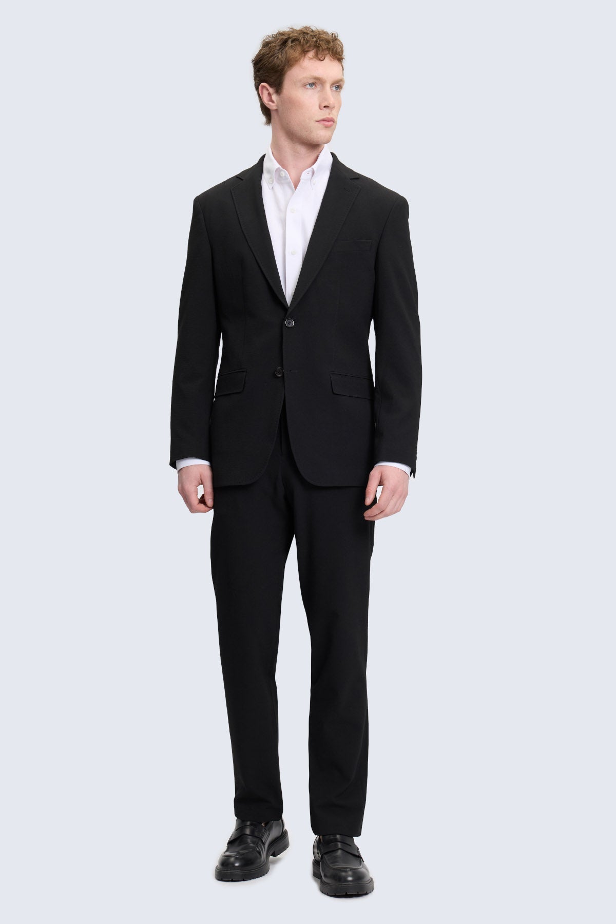 Slim fit black smart casual suit with notch lapel and sleek modern cut featuring two-button closure