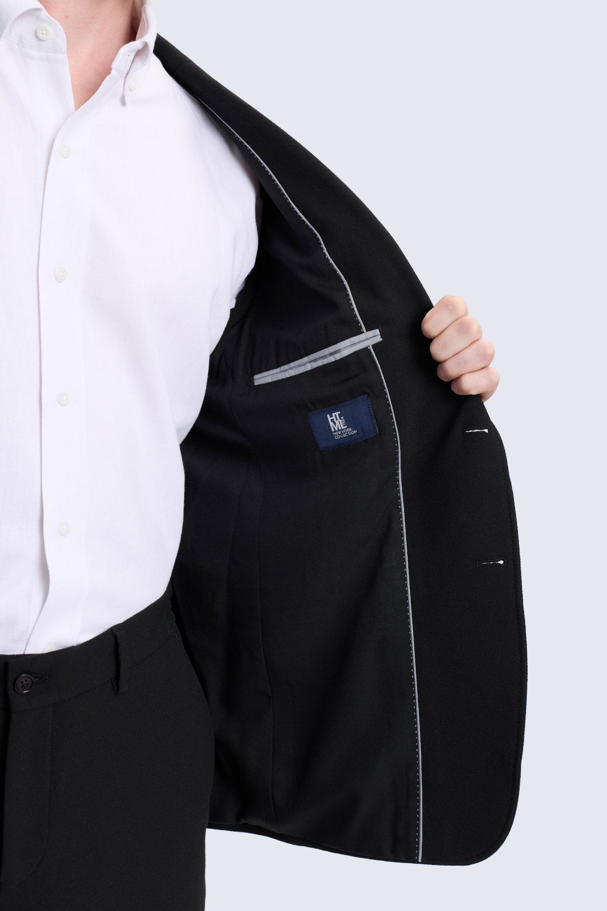 Slim fit black tailored blazer with subtle gray stitching and branded label featuring a notch lapel for smart casual wear