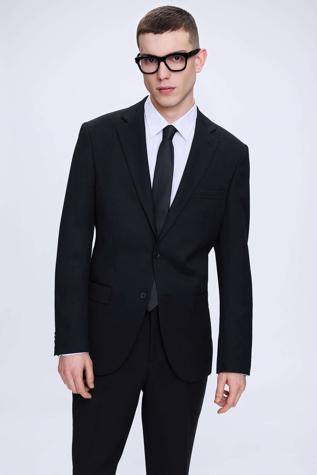 Slim fit notch lapel black smart casual suit with a sleek modern cut and subtle textured tailored fabric