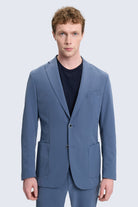 A slim fit notch lapel blue casual suit jacket with a sleek modern cut and subtle texture perfect for smart casual looks